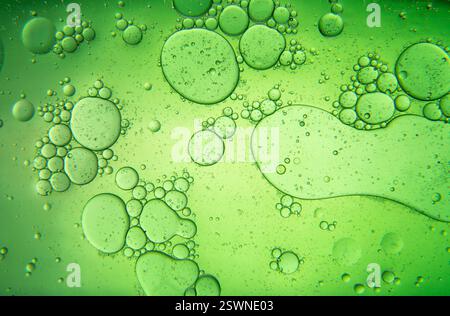 Abstract composition with water and oil drops against dark green background Stock Photo
