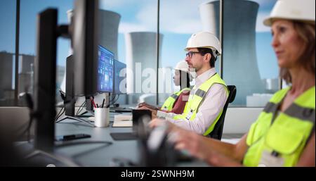 Multiracial Team Operating Scada Software on Modern Desktop Computer at Plant Stock Photo