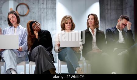 The Unemployed Job Seekers Wait in Boredom for Interviews. A Diverse Team of People Queue for Job Appointments. Stock Photo