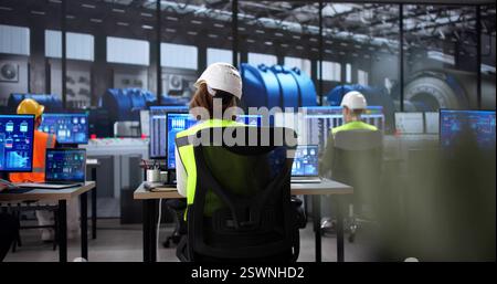 Engineer Controls Power Plant Operations Using Scada Software on Desktop Stock Photo