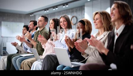 Diverse Team of Businesspeople Applauding During Corporate Training Conference Stock Photo