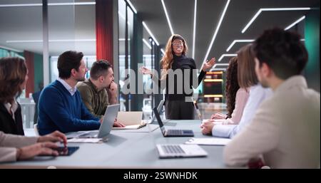 Manager leading interactive workshop for diverse group of professionals. Stock Photo