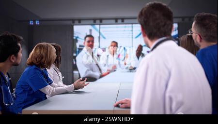 Medical professionals of various ethnicities hold video conference discussing patient care. Stock Photo