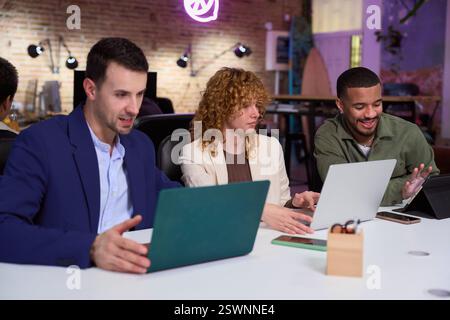 Marketing managers working on laptops in modern office Stock Photo