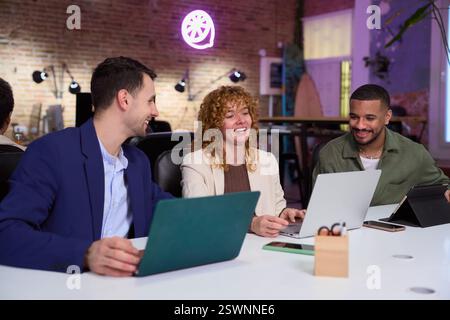 Marketing managers working with laptops in modern office Stock Photo