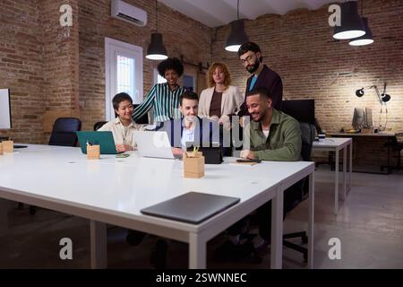 Marketing professionals collaborating on project in modern office Stock Photo