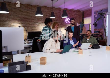 Marketing professionals collaborating on project in modern office Stock Photo