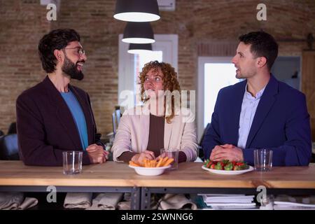 Businesspeople having informal conversation during office break Stock Photo