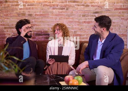 Business people having informal meeting using tablet in modern office Stock Photo