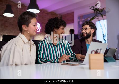 Marketing managers using laptop during business meeting in modern office Stock Photo
