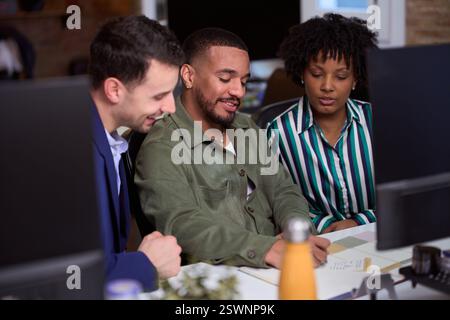 Marketing team working together on project in modern office Stock Photo