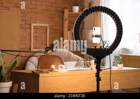 Ring light with mobile phone in blogger's office Stock Photo