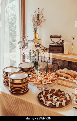 An inviting display of appetizers and cutlery in a rustic and cozy setting. Stock Photo