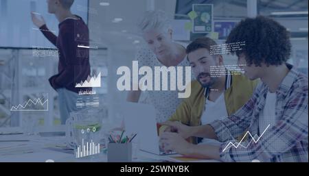 Analyzing data and graphs image over diverse team collaborating in office Stock Photo