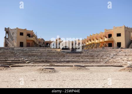 Unfinished resort building stands over an amphitheater in marsa alam, egypt, showing the impact of halted construction projects Stock Photo