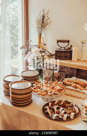 An inviting display of appetizers and cutlery in a rustic and cozy setting. Stock Photo