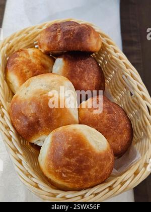Buns in a wicker basket on the table Stock Photo