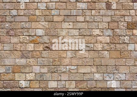Background from a uniform natural stone wall Stock Photo