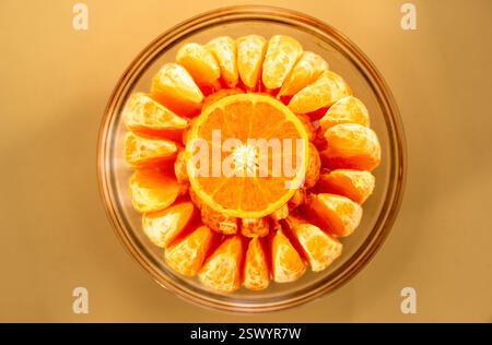 Top-Down View of a Sliced Orange and Peeled Mandarin Segments Arranged in a Glass Bowl, Showcasing Vibrant Citrus Textures and Symmetry Stock Photo