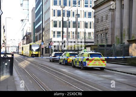Manchester, UK, 22nd February, 2025. A three-year-old girl has died after a collision between a van and a tram in Manchester city centre, police have confirmed. Greater Manchester Police (GMP) said she was taken to hospital but later died from her injuries. The child was a pedestrian and not in either vehicle.  No arrests have been made. The scene on Mosley Street, central Manchester, UK. Media report that the police are looking for the driver of the van. Credit: Terry Waller/Alamy Live News Stock Photo