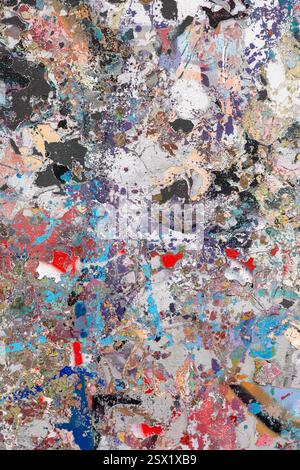 A dynamic abstract painting featuring a textured surface with vibrant splashes of blue, red, purple, and metallic tones. Perfect for backgrounds Stock Photo