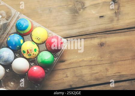Painted Easter eggs lie in rows inside cells on straw Stock Photo