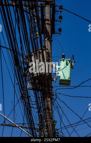 messy electricity wires on the pole, The chaos of cables and wires on an electric pole in Sao Paulo city, Brazil Stock Photo