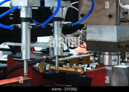 PVC plastic bottle production machine by extrusion and hot blowing technology, industrial concept background Stock Photo