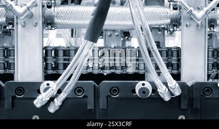 PVC plastic bottle production machine by extrusion and hot blowing technology, industrial concept background Stock Photo