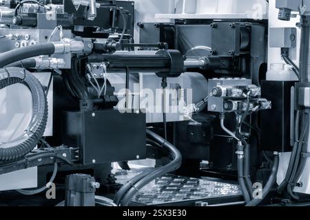 PVC plastic bottle production machine by extrusion and hot blowing technology, industrial concept background Stock Photo