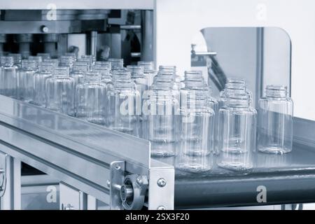 PVC plastic bottle production machine by extrusion and hot blowing technology, industrial concept background Stock Photo