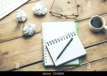 keyboard with notepad,coffee and glasses on table Stock Photo