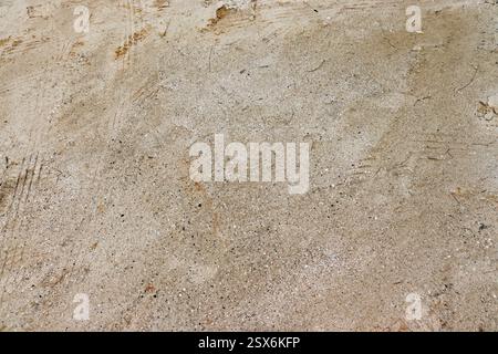 Wet sand on the beach, meant to be used as a background. Stock Photo