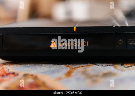 Paris, France - Feb 17, 2025: A close-up of an Orange TV box displaying an illuminated error message Erreur S01-01 in orange text, indicating a possib Stock Photo