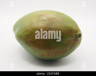Isolated close-up of a mango fruit seen from the side on white background. Concept: ingredients, healthy eating, cooking, Stock Photo