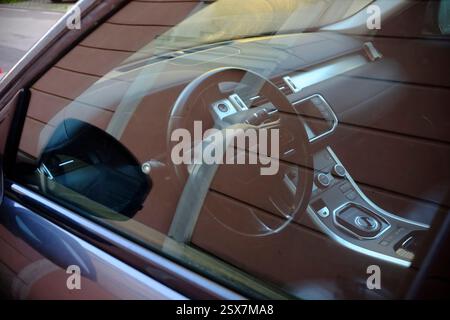 Cremona, Italy February 9th 2025 Interior view of a Range Rover Evoque, focusing on the brown leather steering wheel and dashboard controls Stock Photo