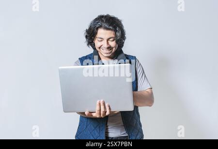 Happy guy using laptop isolated. Smiling handsome man looking at a promotion on laptop isolated Stock Photo