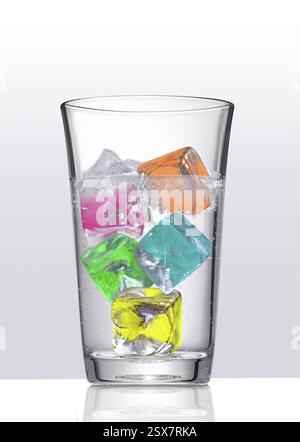 Water glass with coloured ice cube cubes Stock Photo