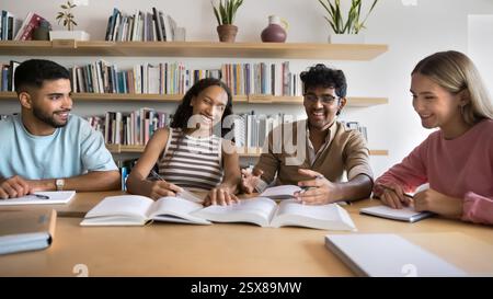 Happy multiethnic students studying together in library Stock Photo
