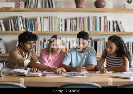Group of four students engaged in collaborative study session Stock Photo