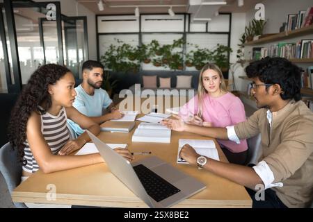 Group of students researching, studying together met in library Stock Photo