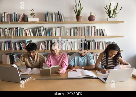 Group of focused multinational students studying together in library Stock Photo
