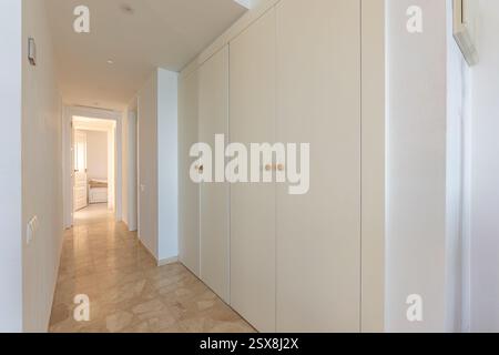 an image of white fitted wardrobes in master bedroom of holiday apartment Stock Photo
