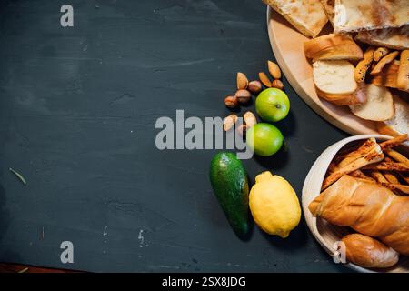 Pastries, bread, nuts, lemon and avocado on a gray background Stock Photo
