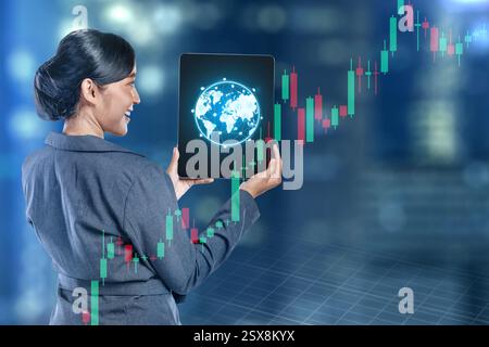 Businesswomen show global world map connection on a tablet screen with holographic economic chart, global economic trend on virtual screen. Concept of Stock Photo