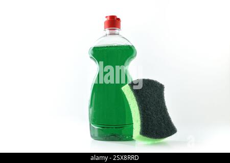 Plastic bottle with dishwashing soap and green scouring pad with abrasive and sponge surfaces isolated on white background. Front view. Stock Photo