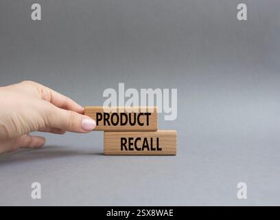 Product recall symbol. Concept words Product recall on wooden blocks. Beautiful grey background. Businessman hand. Business and Product recall concept Stock Photo