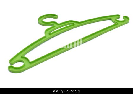 Green plastic clothes hanger on a white background. Stock Photo