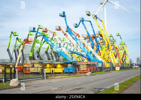 Colourful aerial work platforms at a business park in logistics park Doelwijk in Waddinxveen, Netherlands Stock Photo