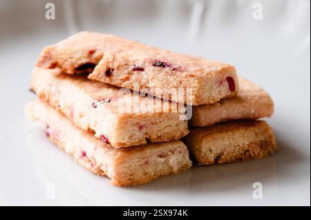 Stack of shortbread cookies with dry fruit in them on a white plate Stock Photo